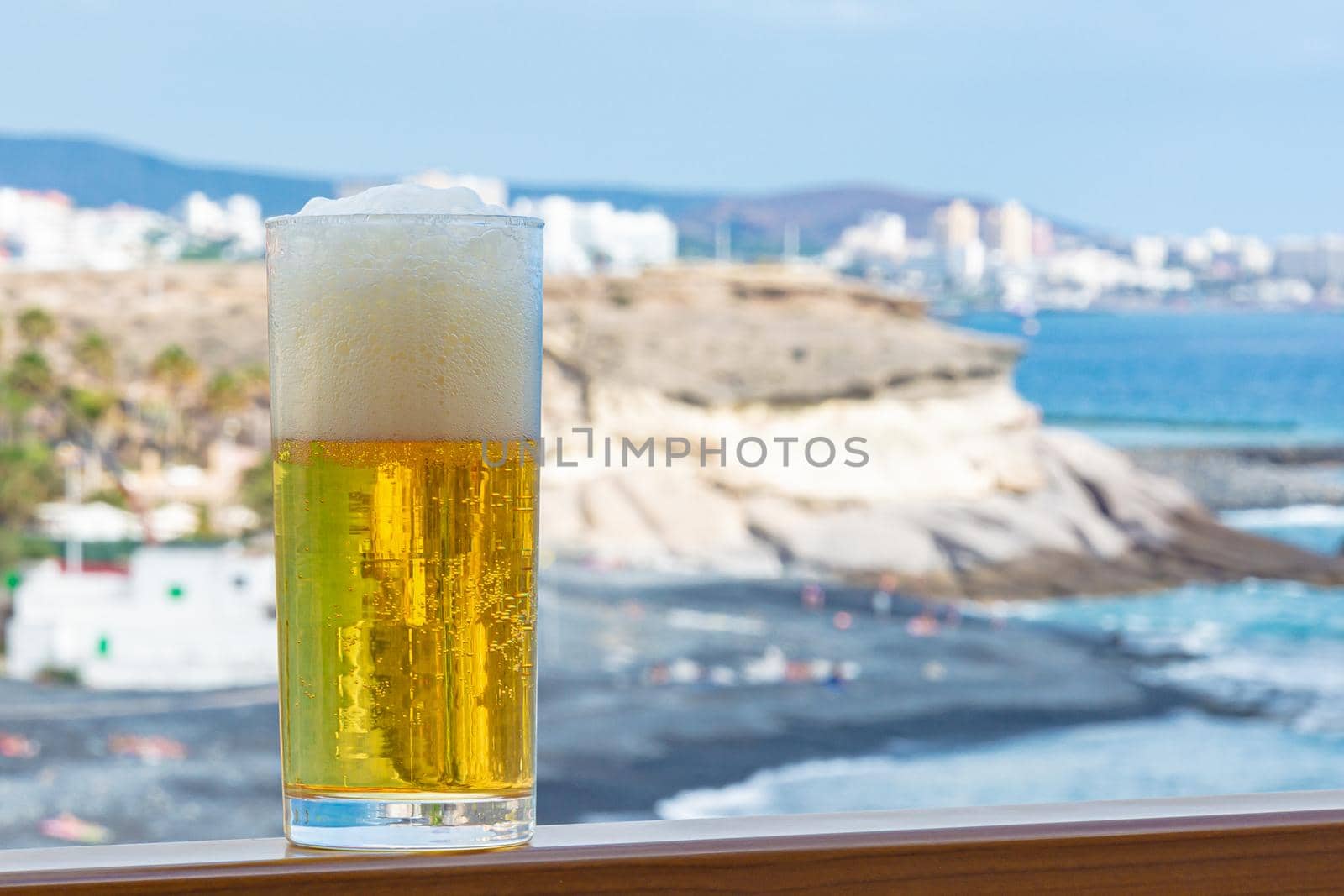 glass of light foamy beer in close-up on a blurry background by Grommik