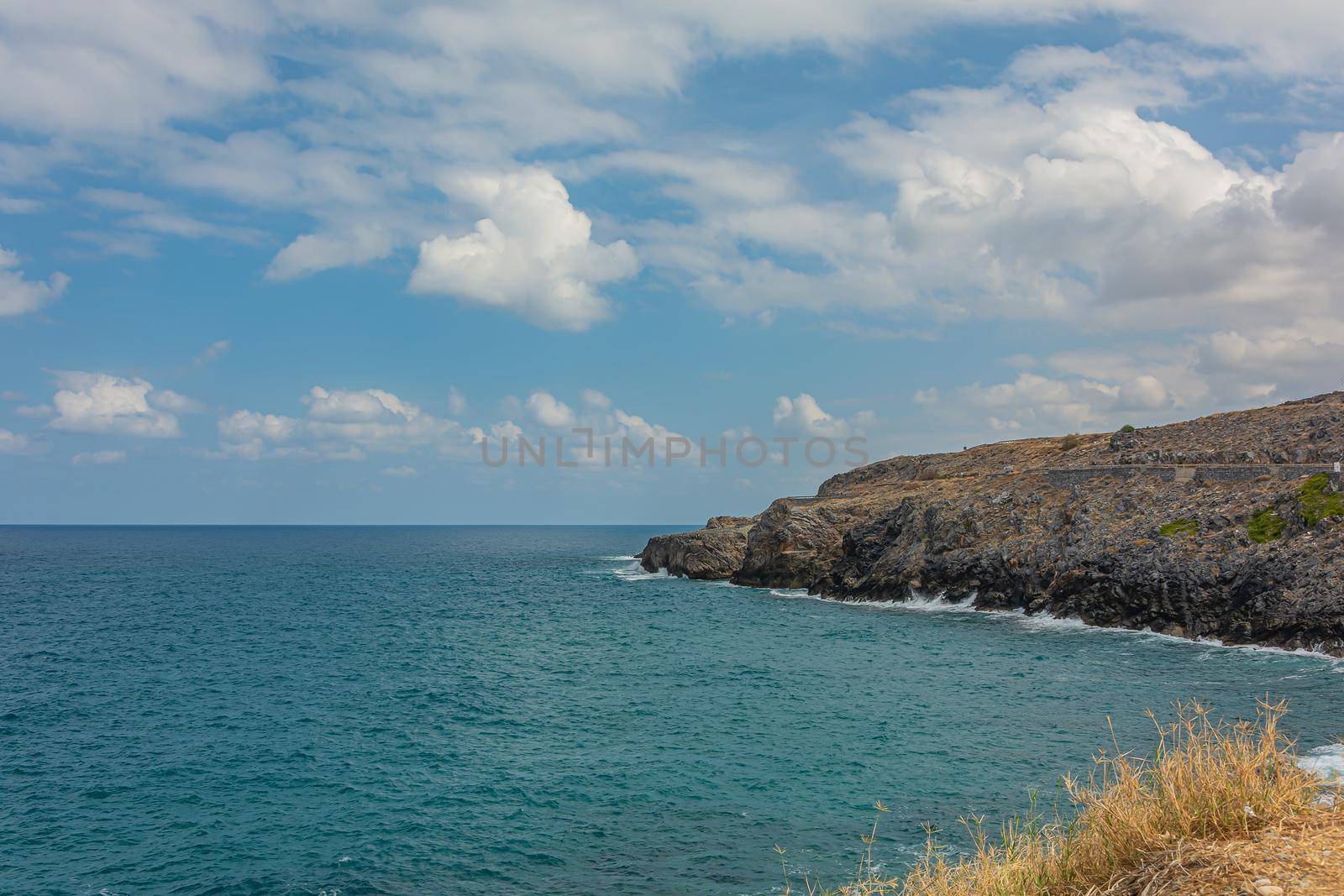 Seascape. The rocky coast of their cloud in the sky. Stock photography