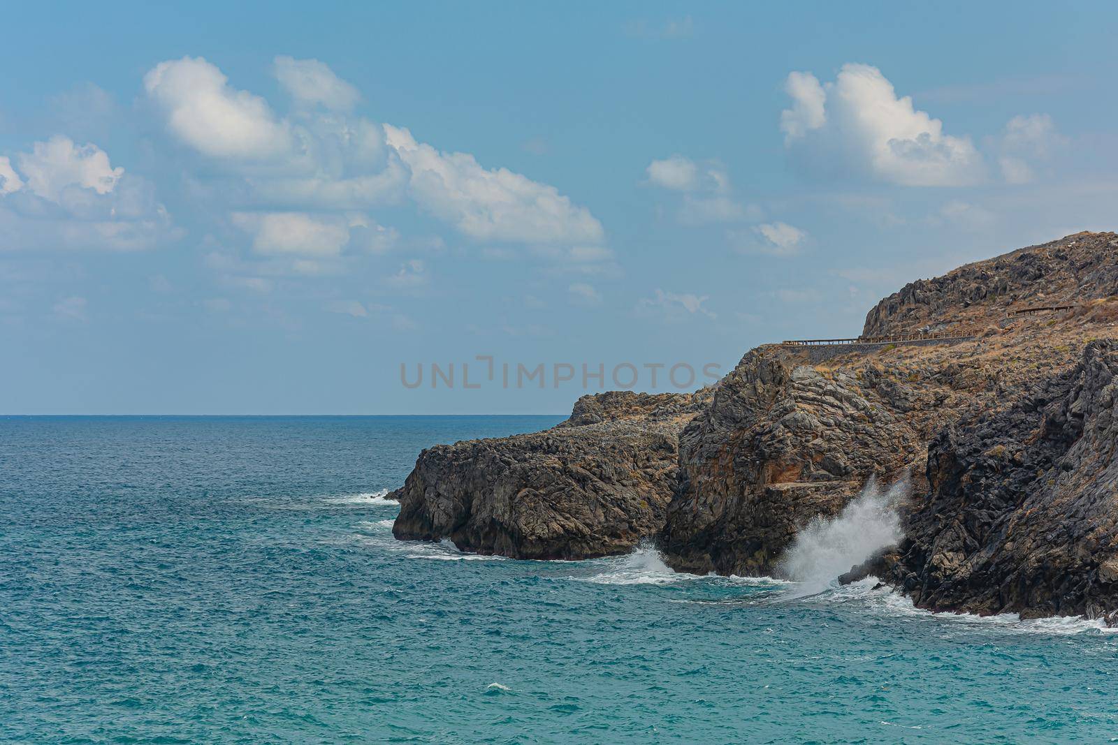 Seascape. The rocky coast of their cloud in the sky by Grommik