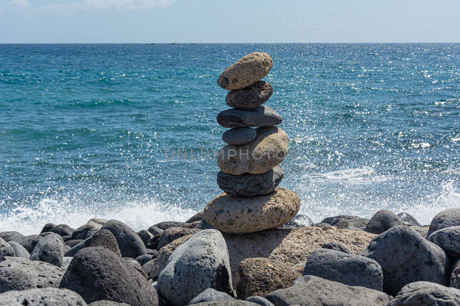 Seascape. Pyramid of stones on a rocky shore against the sea. Stock photography