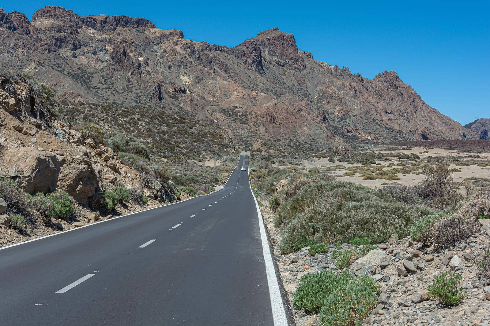 Mountain landscape. Road in a mountainous area at the foot of the mountain. Stock photo