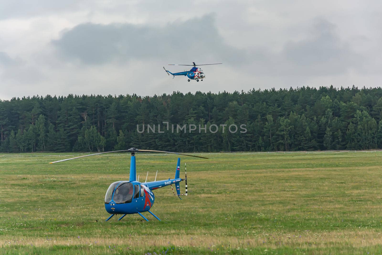 Belarus, Minsk - 07/25/2018: The helicopter is on the field of the airfield and the second helicopter comes in for landing. Stock photography