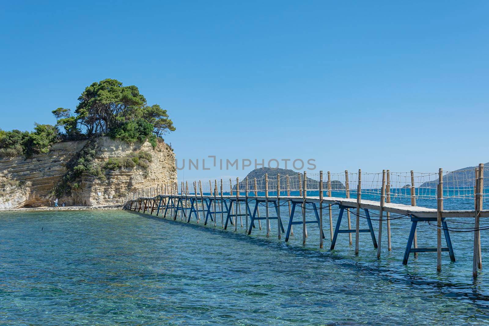 Seascape. Bridge to the island remote from the shore. Stock photo