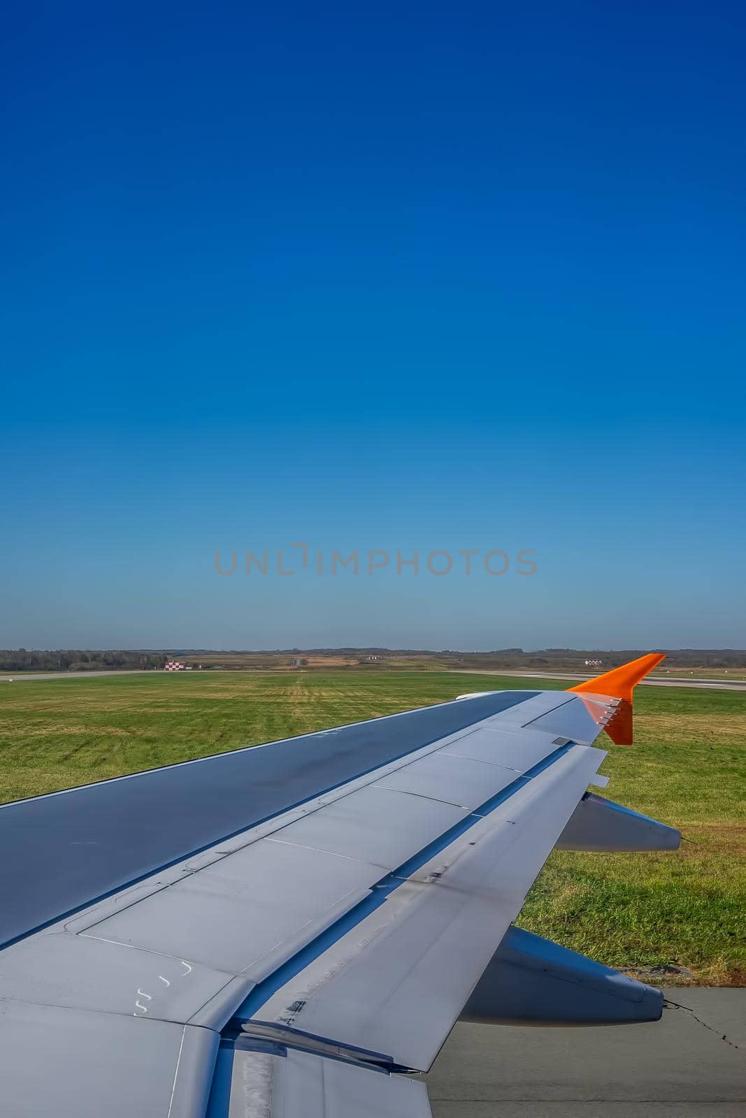 Airplane wing on the background of the landscape.