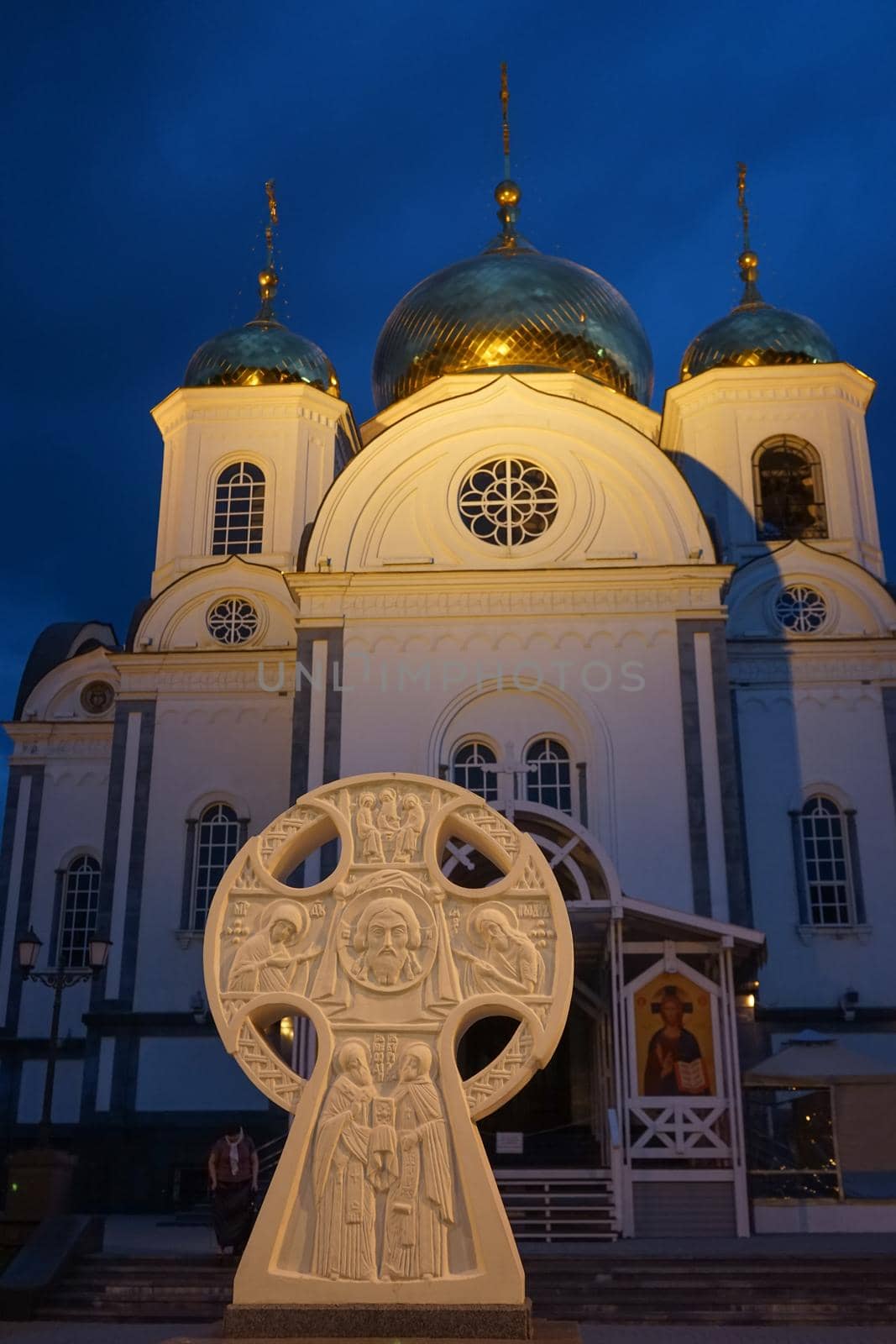 Christian Church against the evening sky lit by the rays of searchlights in the city of Krasnodar