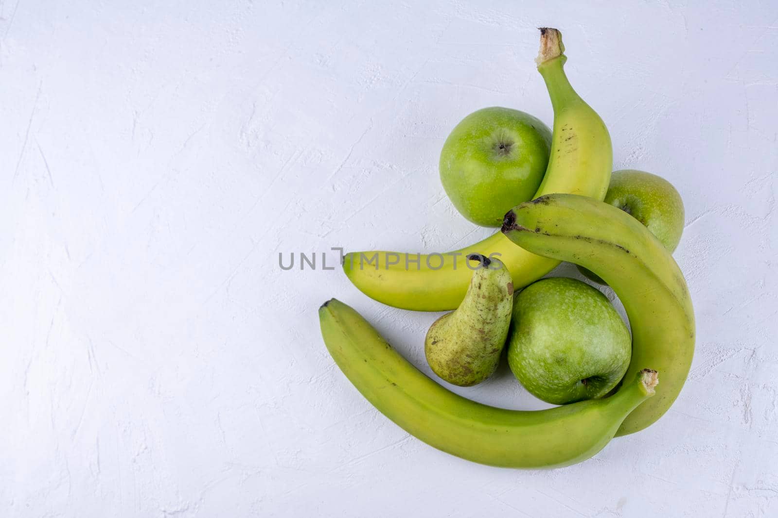 Fresh green apples, pears, bananas on a white wooden background. Concept healthy food photo. by sashokddt