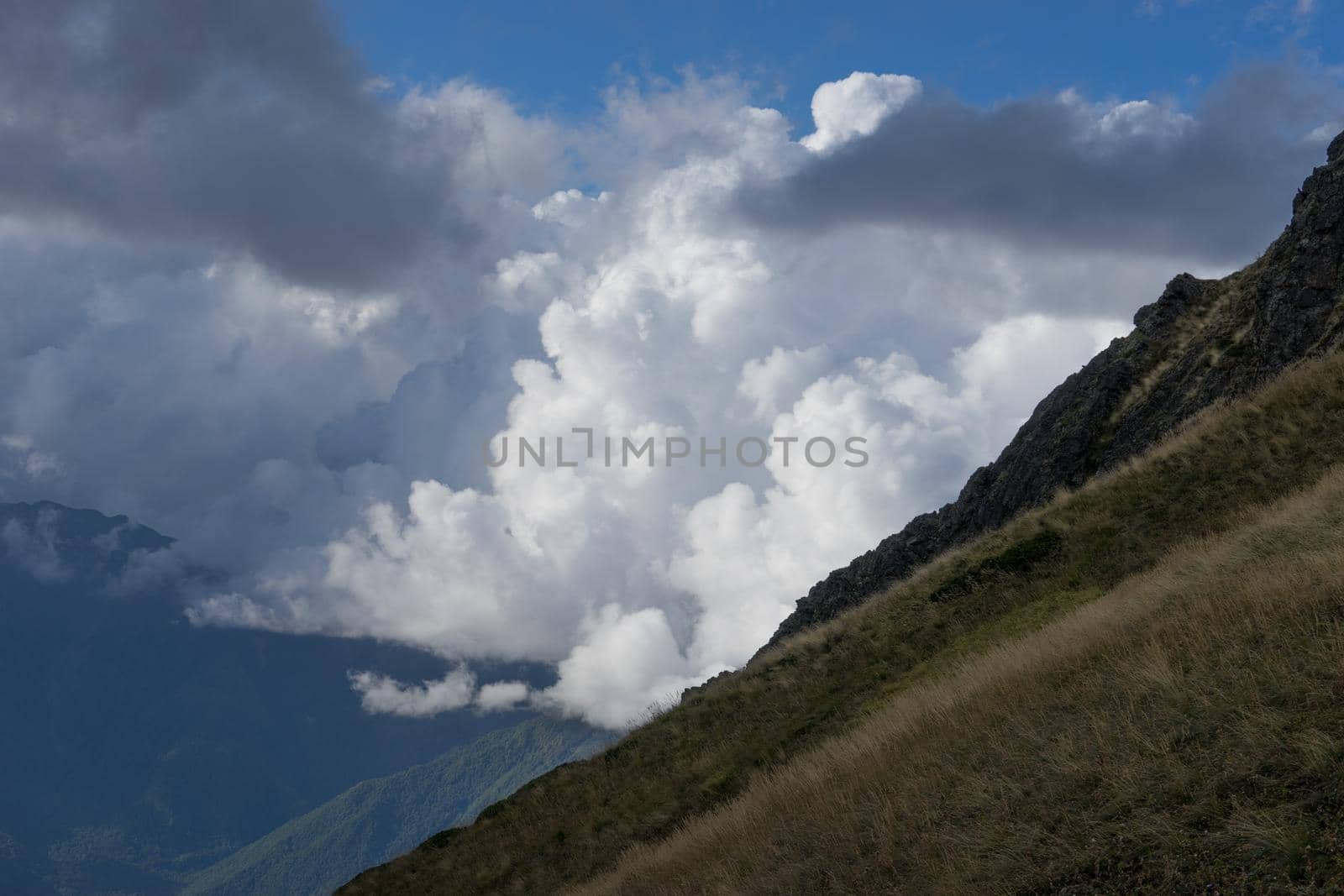 mountain landscape on the background of the cloudy sky and sun rays