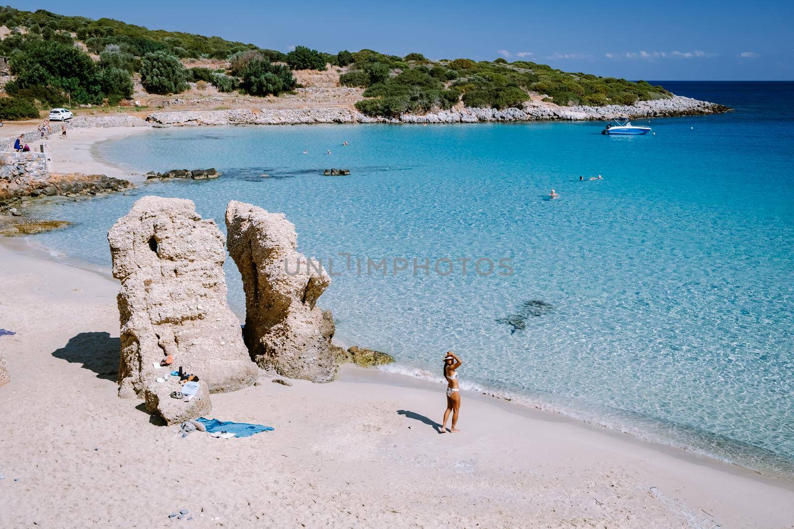 Young happy couple on seashore Crete Greece, men, and woman Voulisma beach Crete Greece. Europe