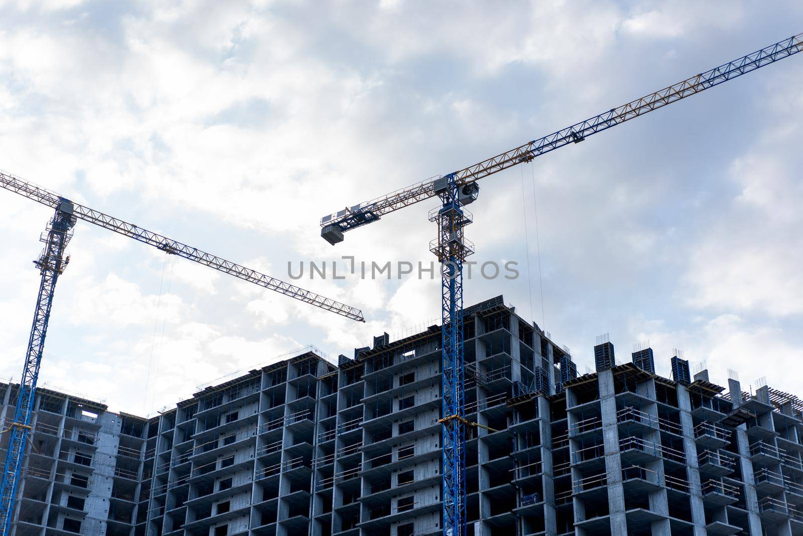 Construction site with Construction crane and cloudy sky on background