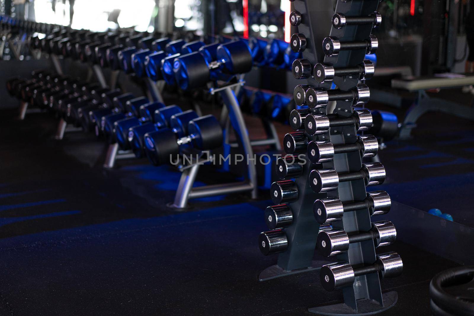 Dumbbells in a row at gym Dark toned Healthy lifestyle fitness concept
