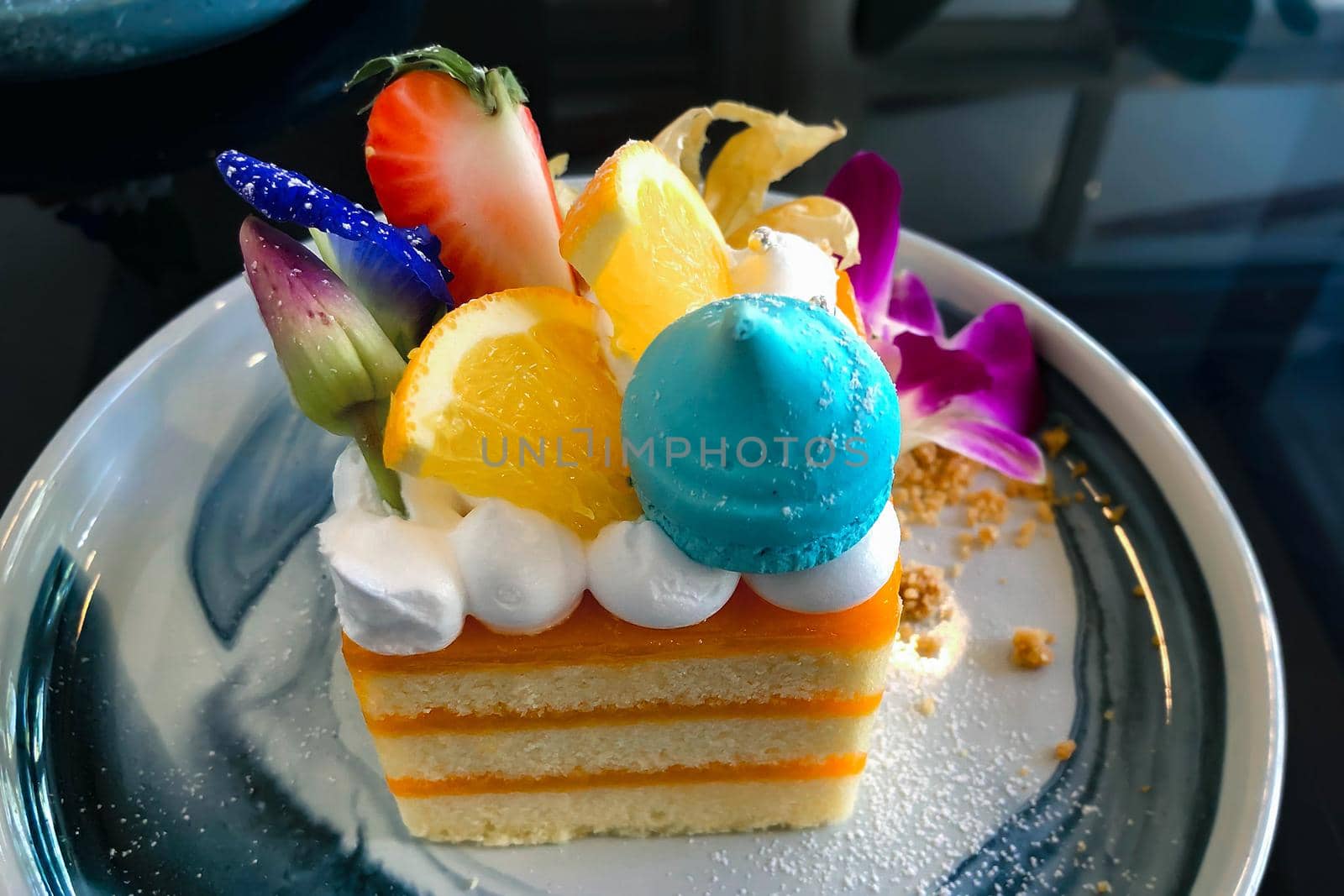 Orange cake with orange topping on plate ready to eat