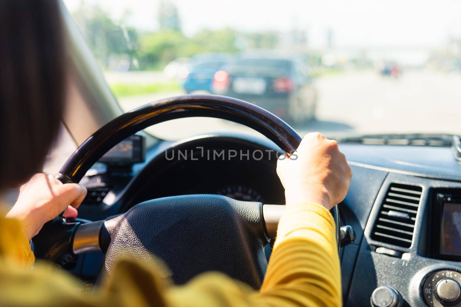 Asian woman while driving the car in the morning during going to work on highway road, Transportation and vehicle concept