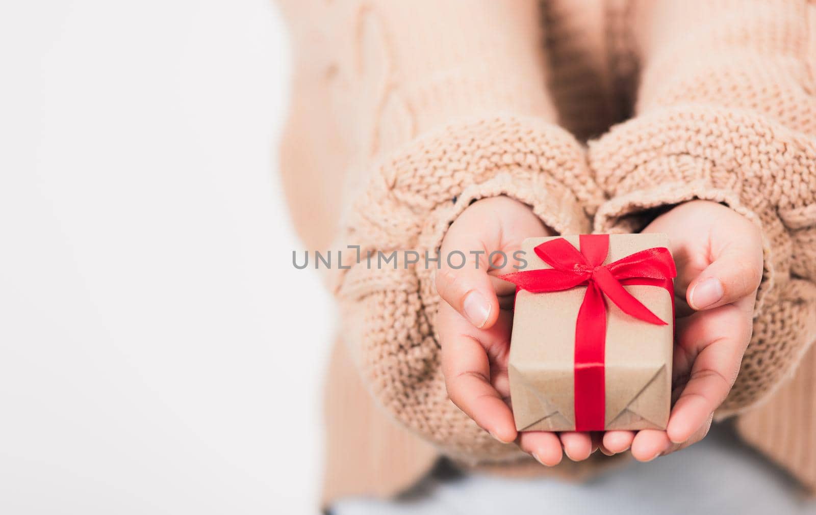 Valentine Day. Woman beauty hands holding small gift package box present wrapped paper with ribbon, Christmas, New year, Birthday holiday background concept