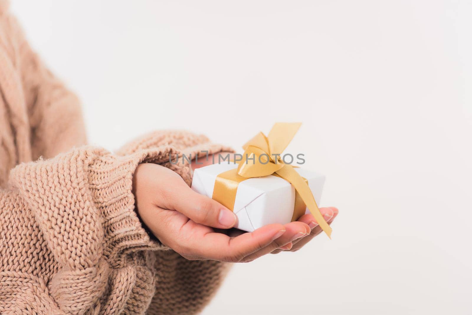 Valentine's Day. Woman beauty hands holding small gift package box present wrapped paper with ribbon isolated on white background, Birthday, New year, Christmas, holiday background concept