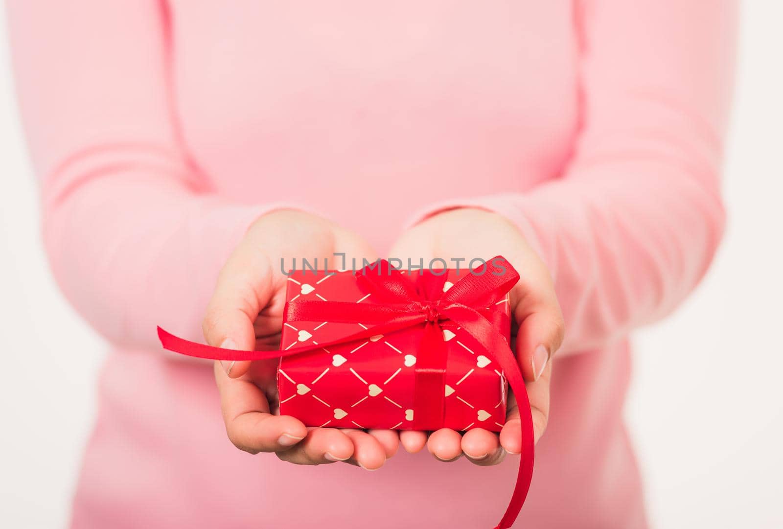 Female beauty hands holding small gift package box present by Sorapop