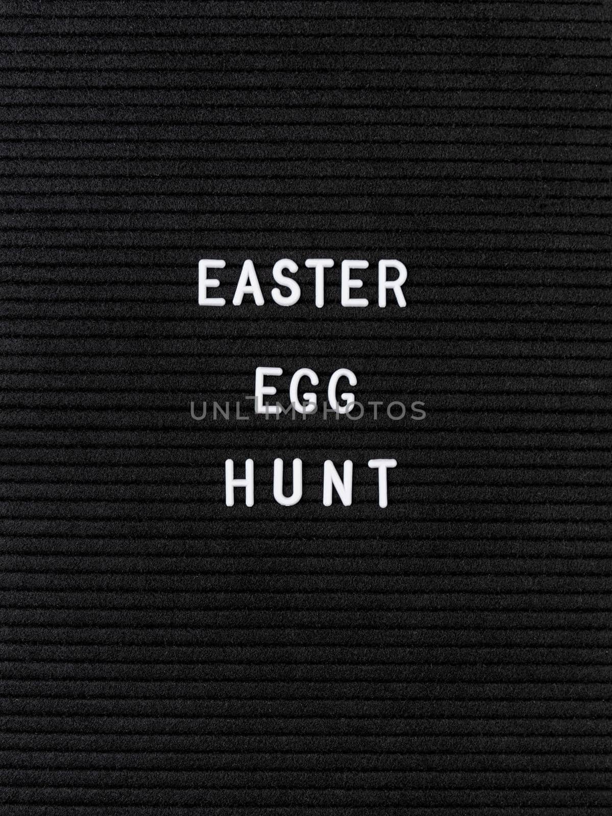 The words Easter Egg Hunt on black felt letter board by Desperada