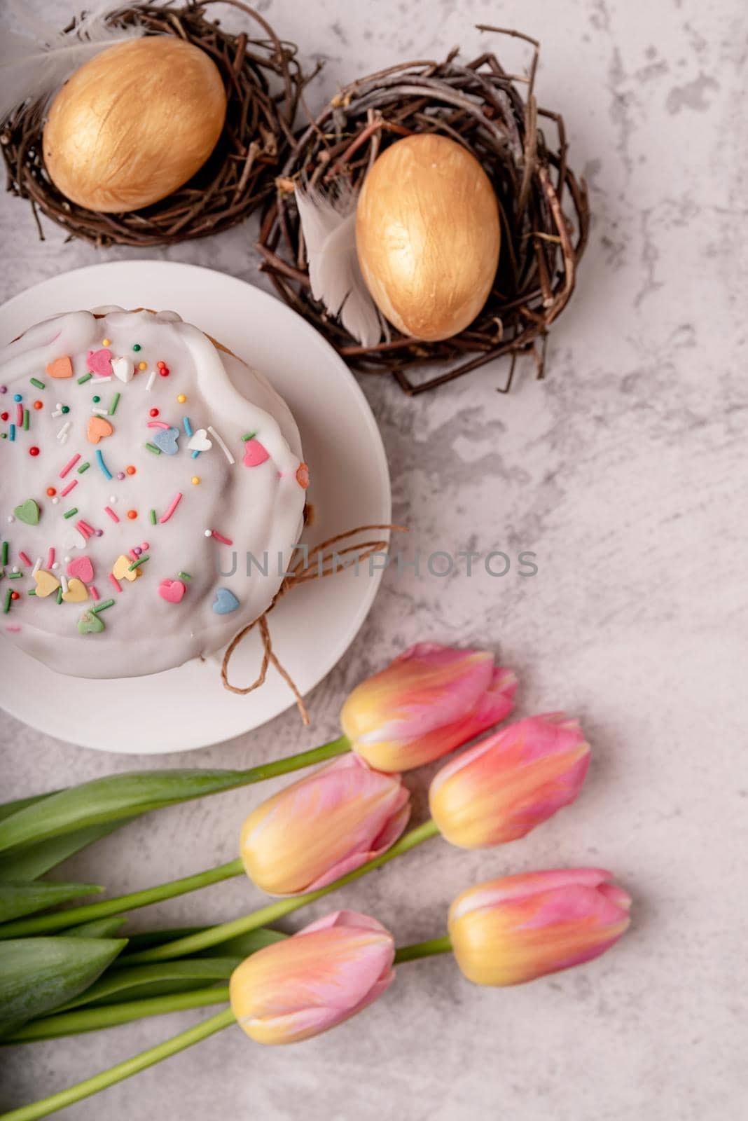 Easter cake with tulips and colored eggs top view flat lay by Desperada