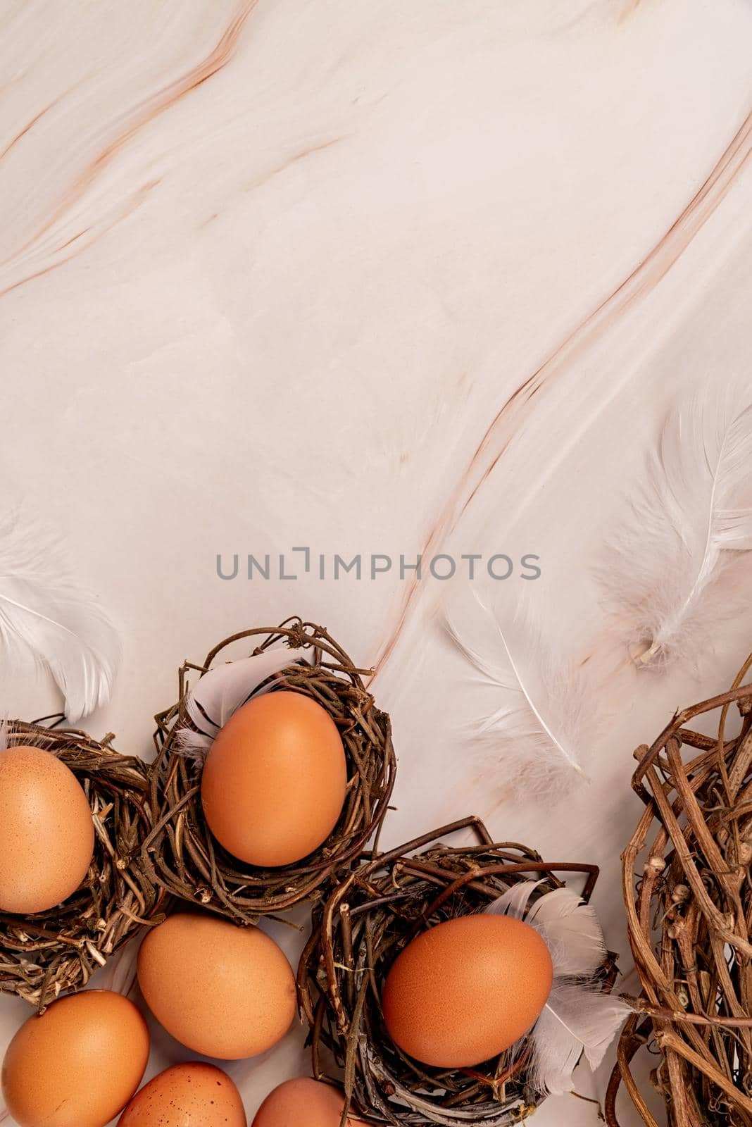 Easter concept. Nests with brown eggs top view flat lay on marble background