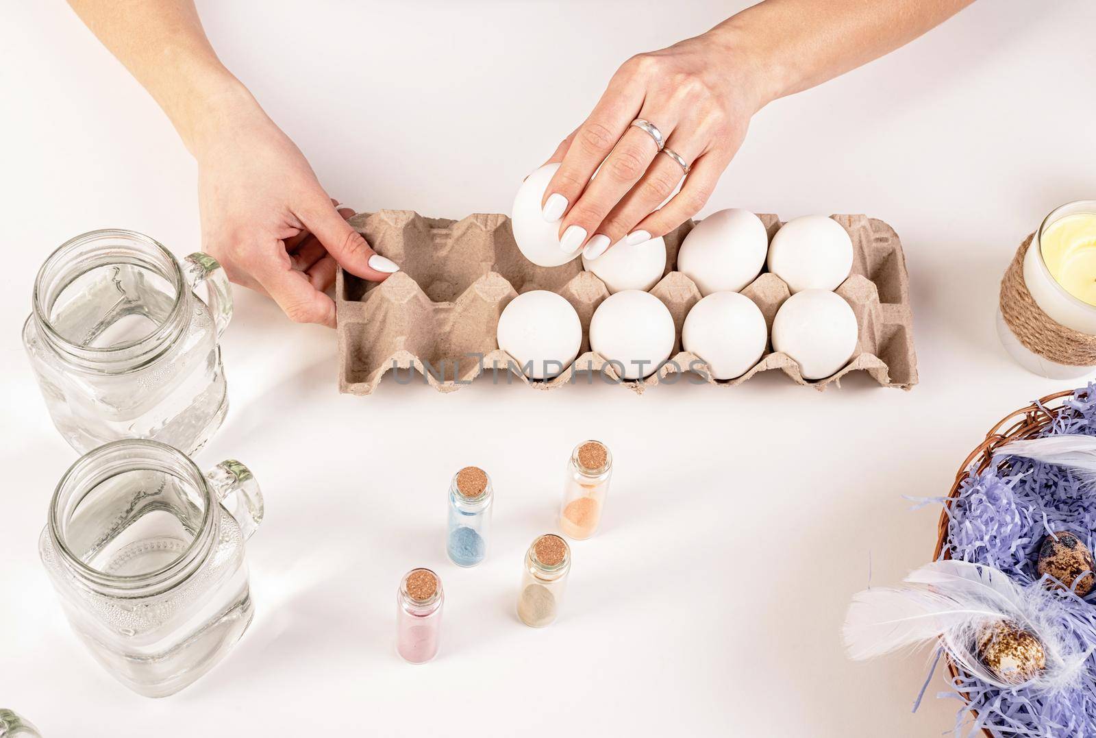 Easter concept. Woman hands holding eggs redy for coloring
