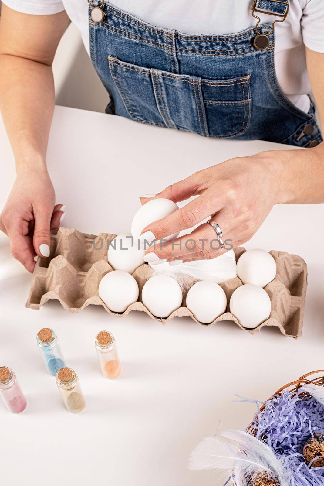 woman hands holding a white egg ready for easter egg coloring top view by Desperada