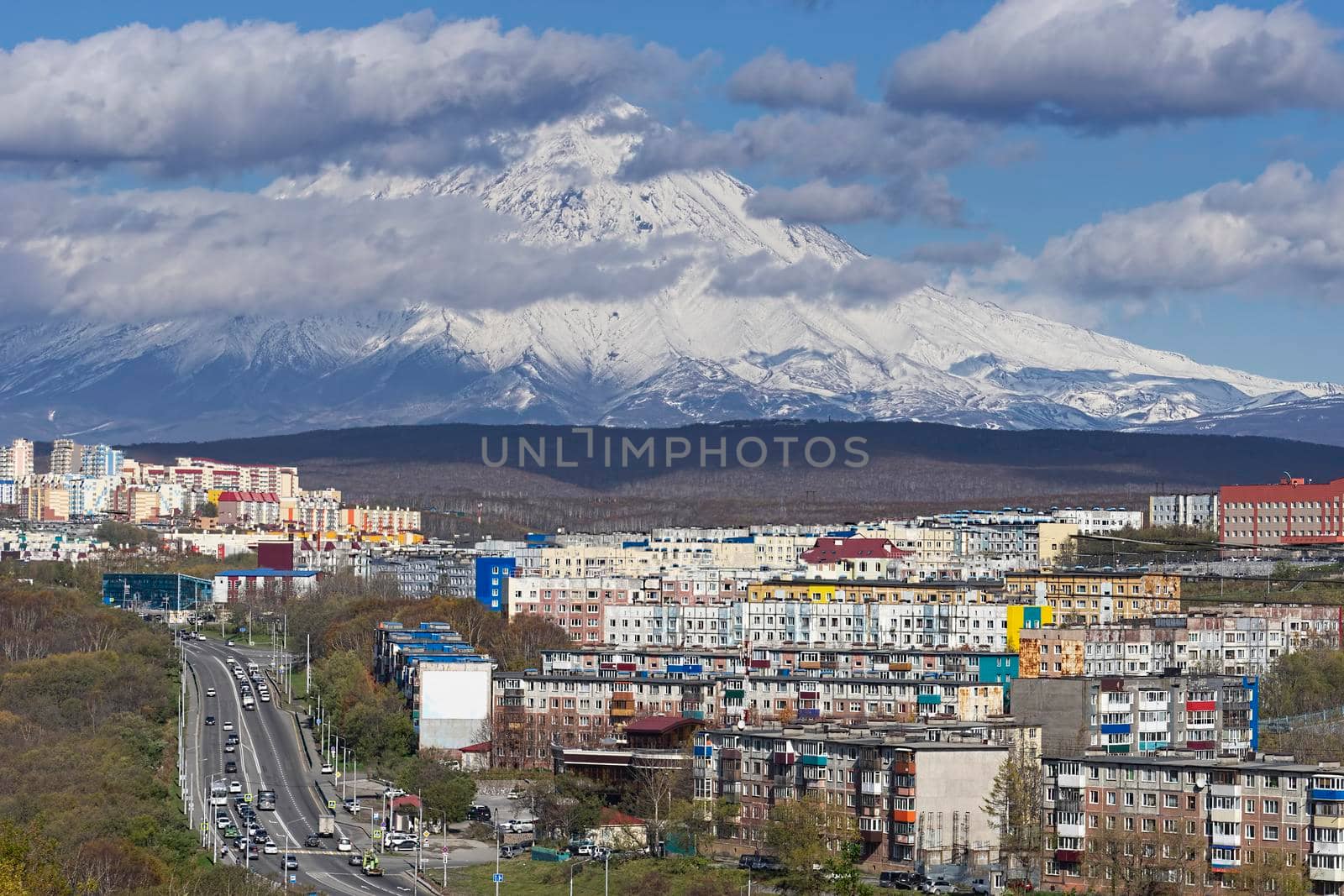 Petropavlovsk-Kamchatsky. Urban landscape with buildings and streets on the background of the volcano.