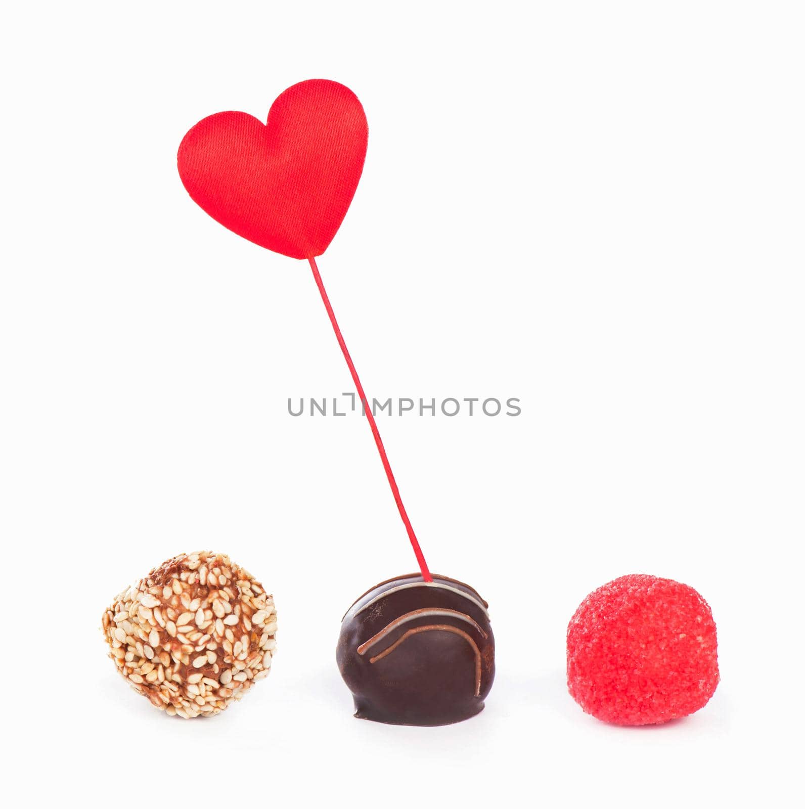 Valentine's Day. Gift box and candy in the form of a heart on a white background by aprilphoto