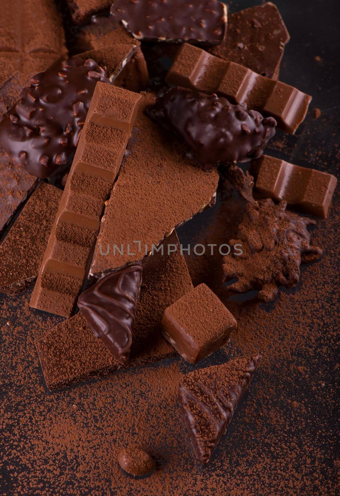 dark chocolate over wooden background, selective focus.