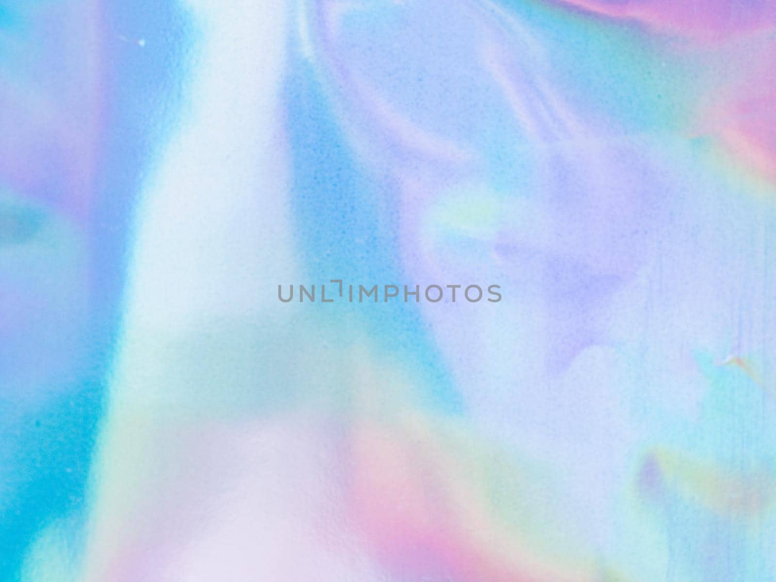 Beautiful holographic rainbow abstract background in pastel and neon color design. Real photography shot of holographic foil for creative project - design fashion, cover, book, printing. Copy space