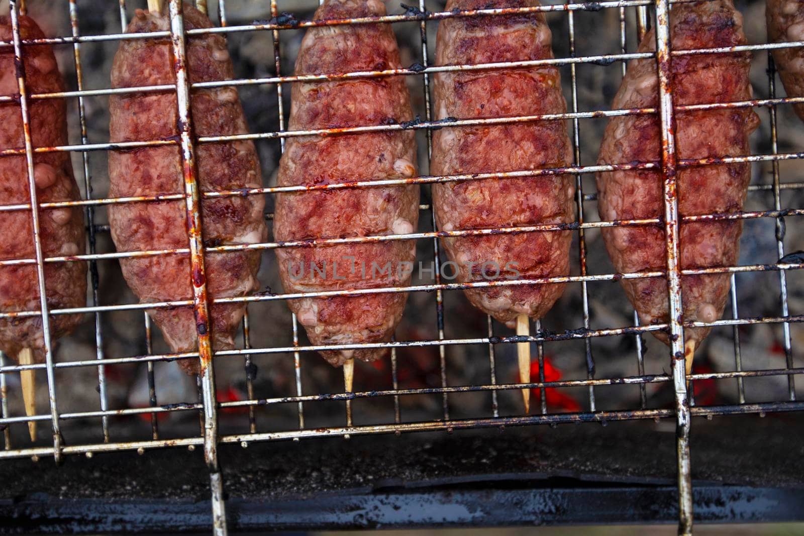 Meat dish on the wire rack. Lula kebab oriental sausages.