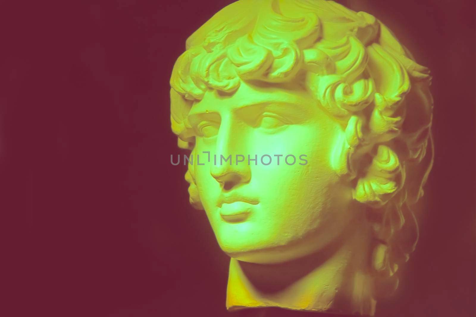 Blurred plaster decorative statue of Apollo's head in vintage color.