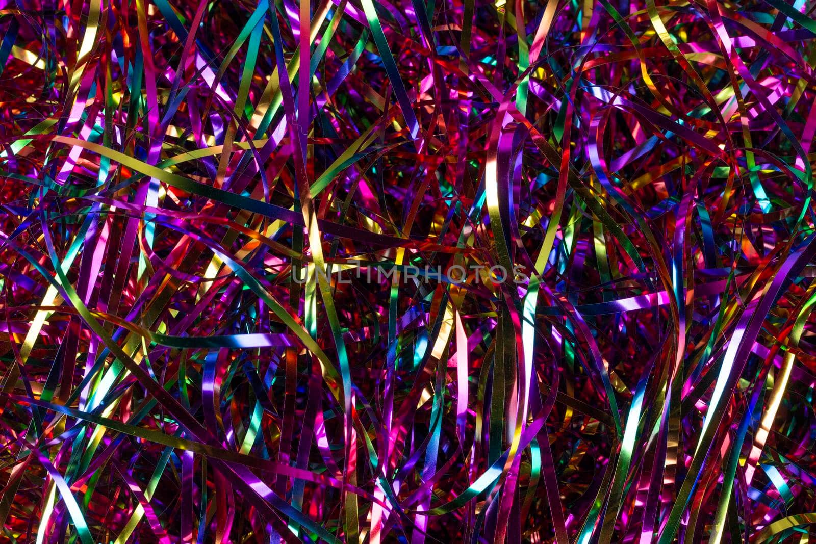 Festive background. Lots of multicolored tinsel close-up.