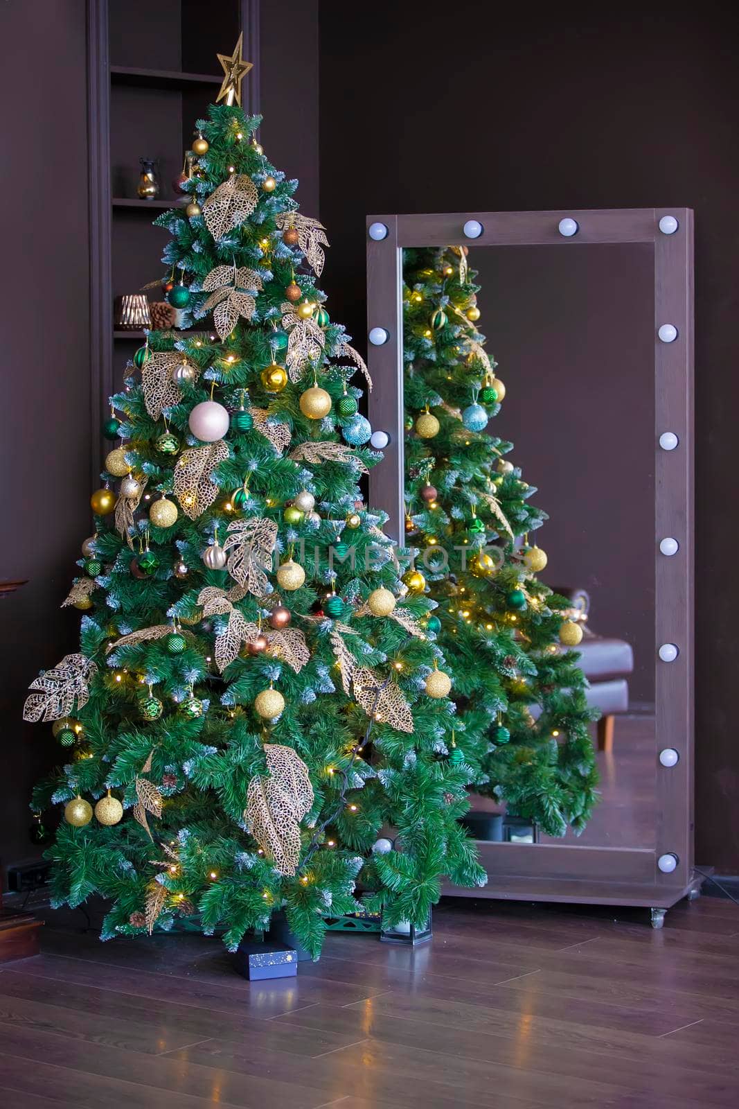 Christmas tree on a brown background in an interior photo studio.