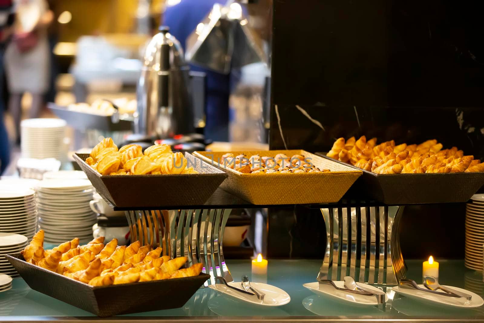 Cookies or small cakes in a bowl at a buffet table.