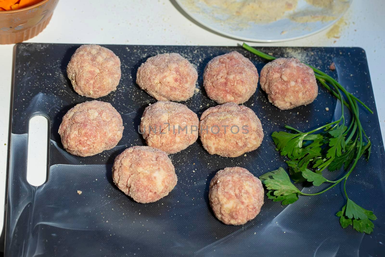 Cooking meat cutlets. Semi-finished meatballs on a cutting board.