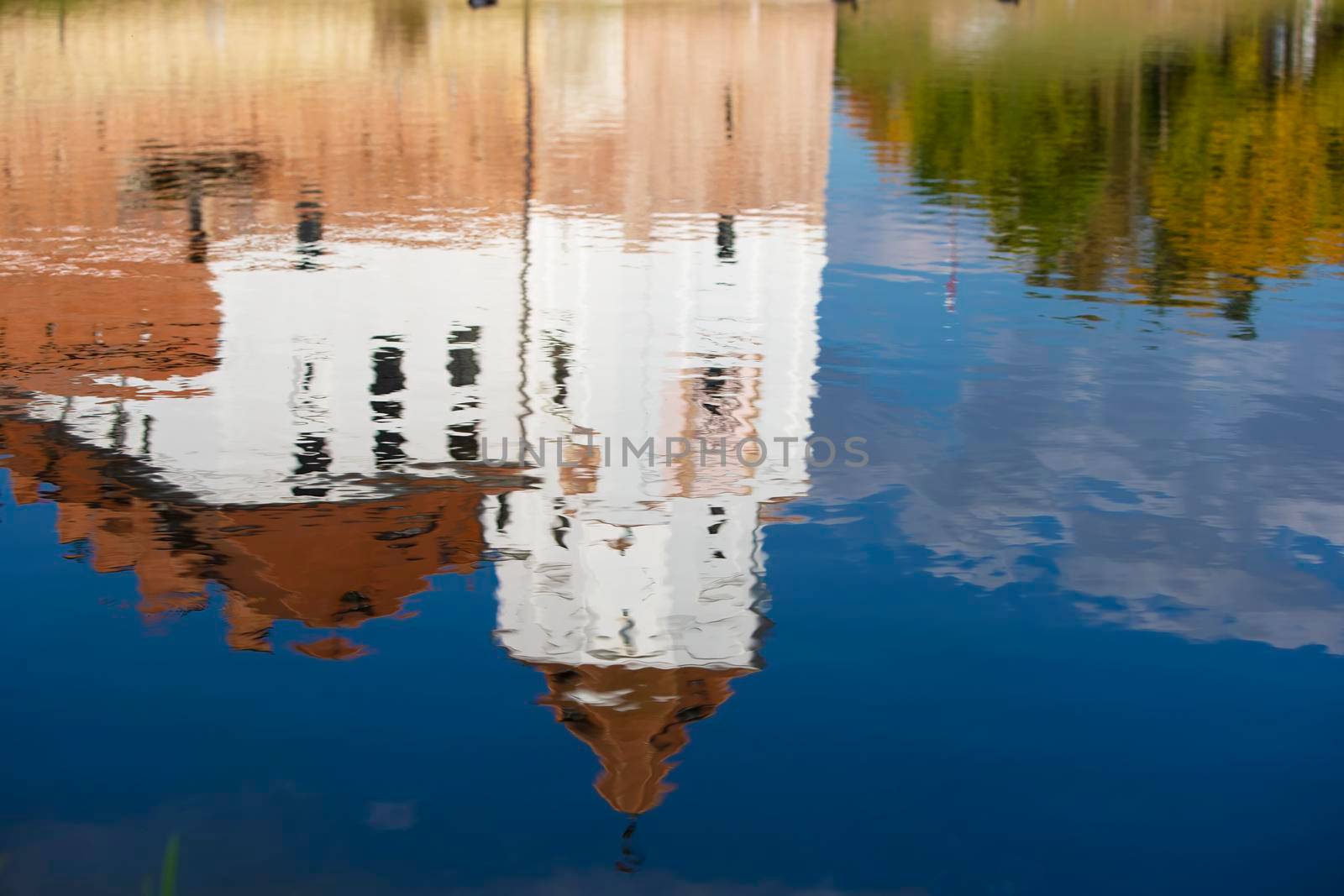 Reflection of an old castle in blue water.