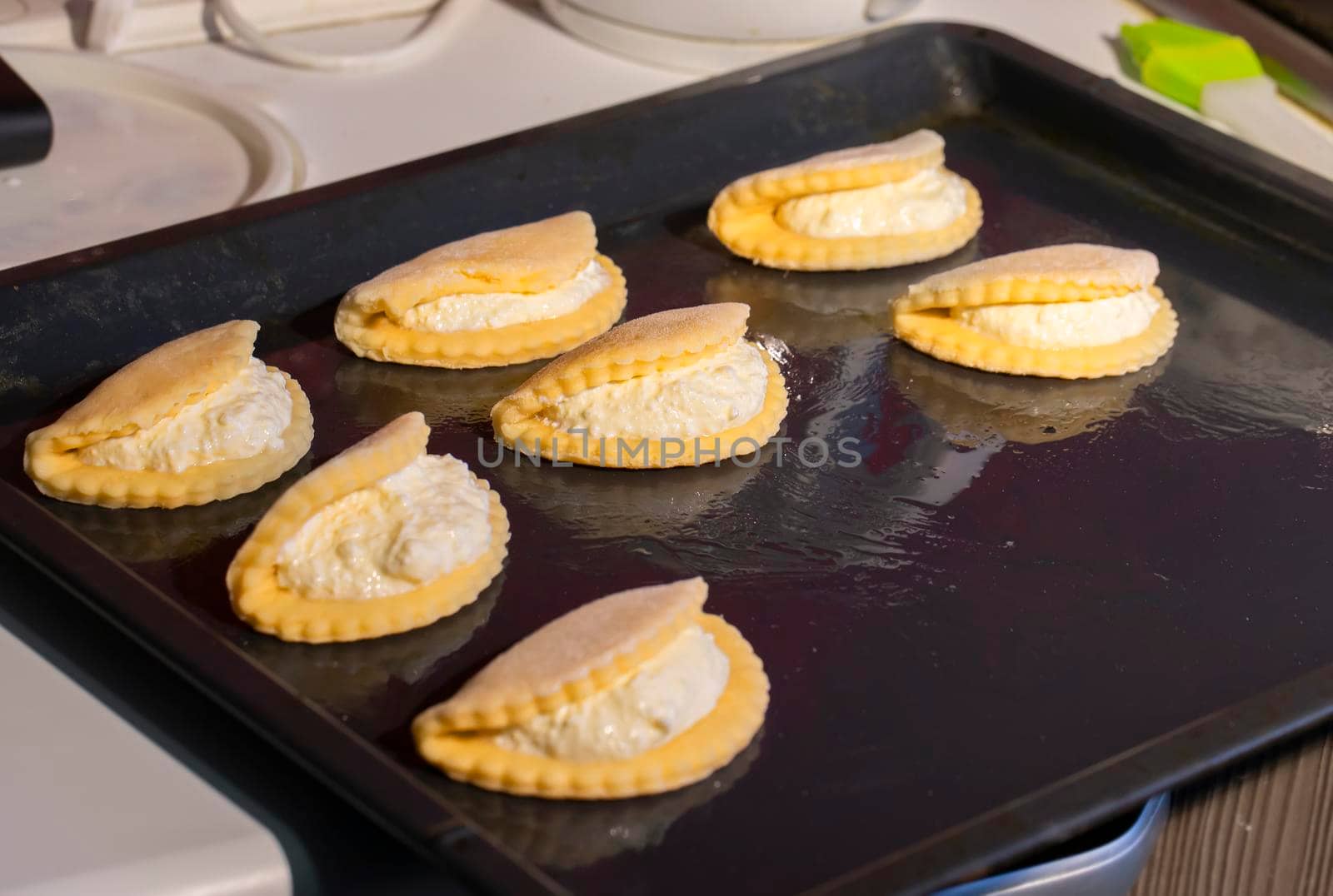 On a baking sheet there are cookies with cottage cheese.