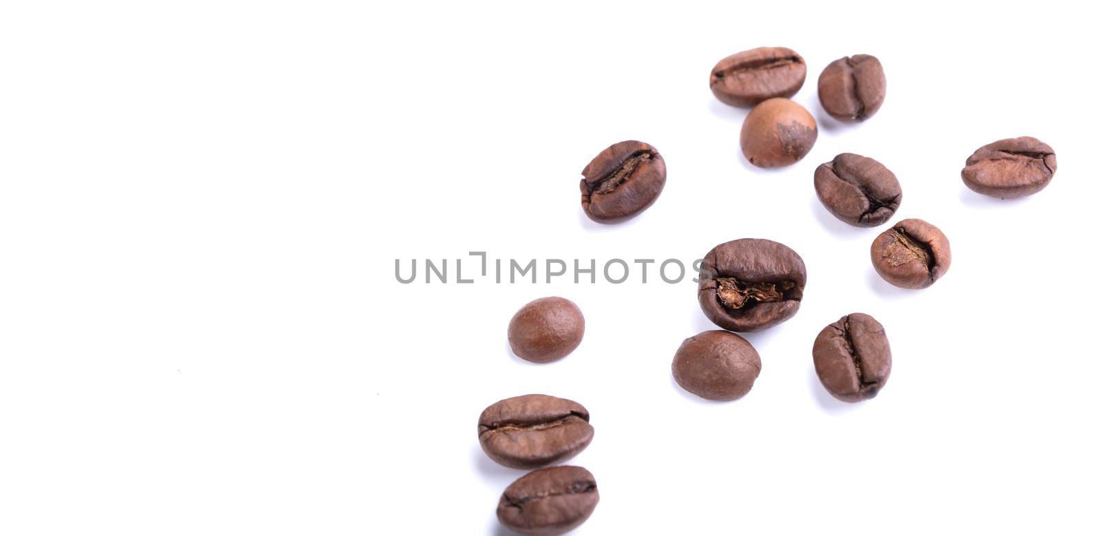 Scattered coffee beans on a white background. Arabica or robusta.