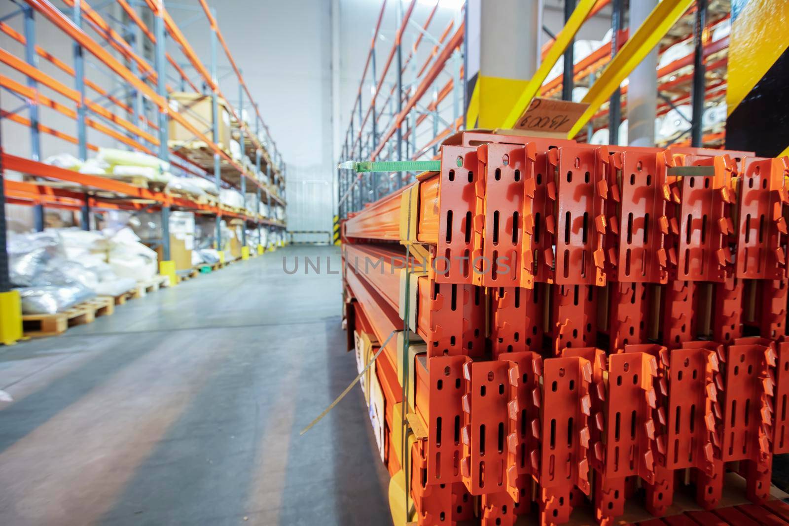 Warehouse premises of a factory or workshop with metal shelves.