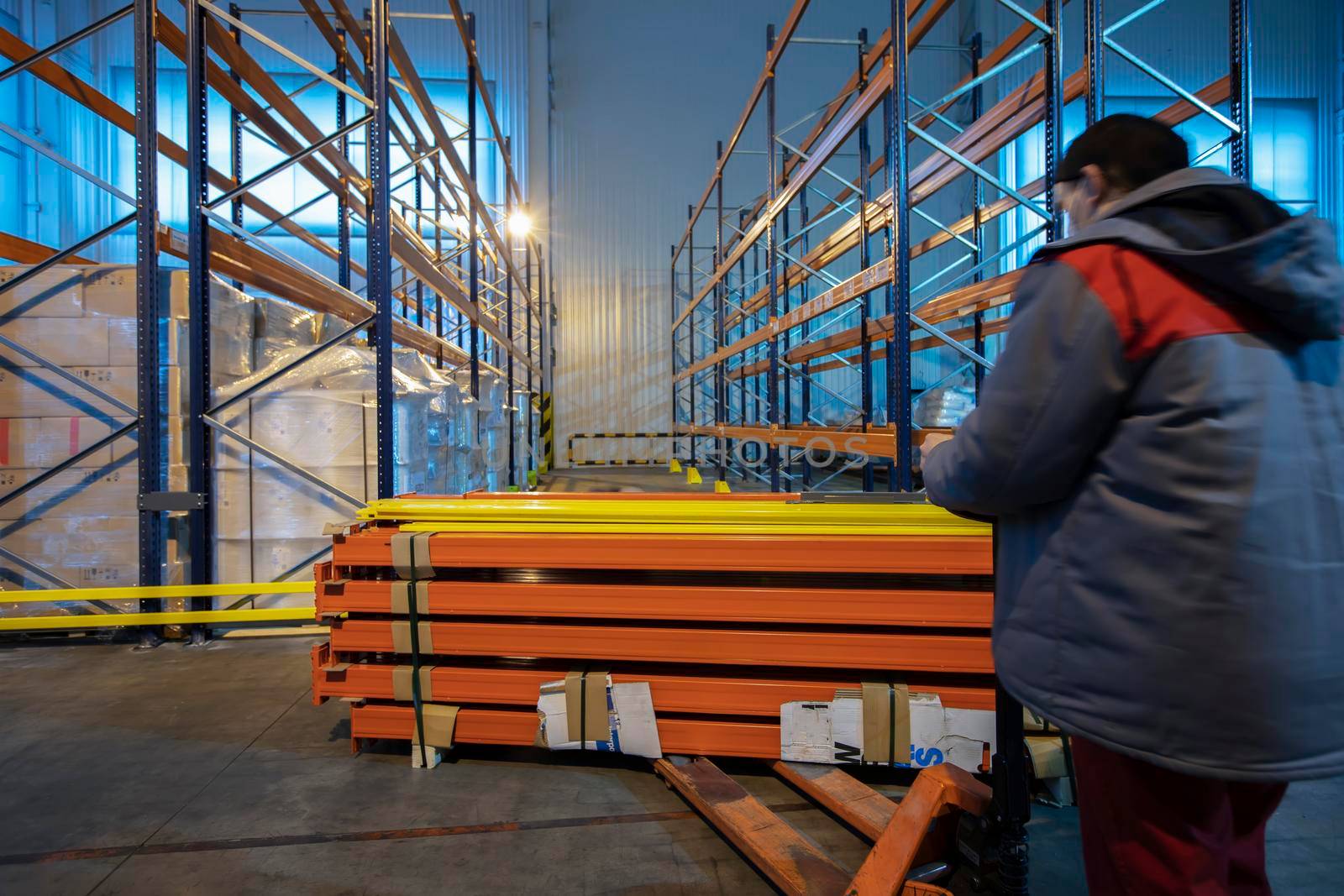 Warehouse premises of a factory or workshop with metal shelves.