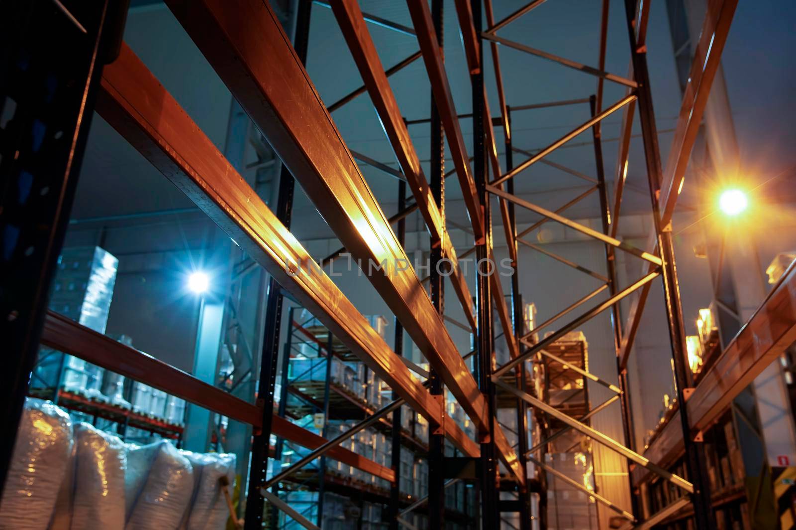 Warehouse premises of a factory or workshop with metal shelves.