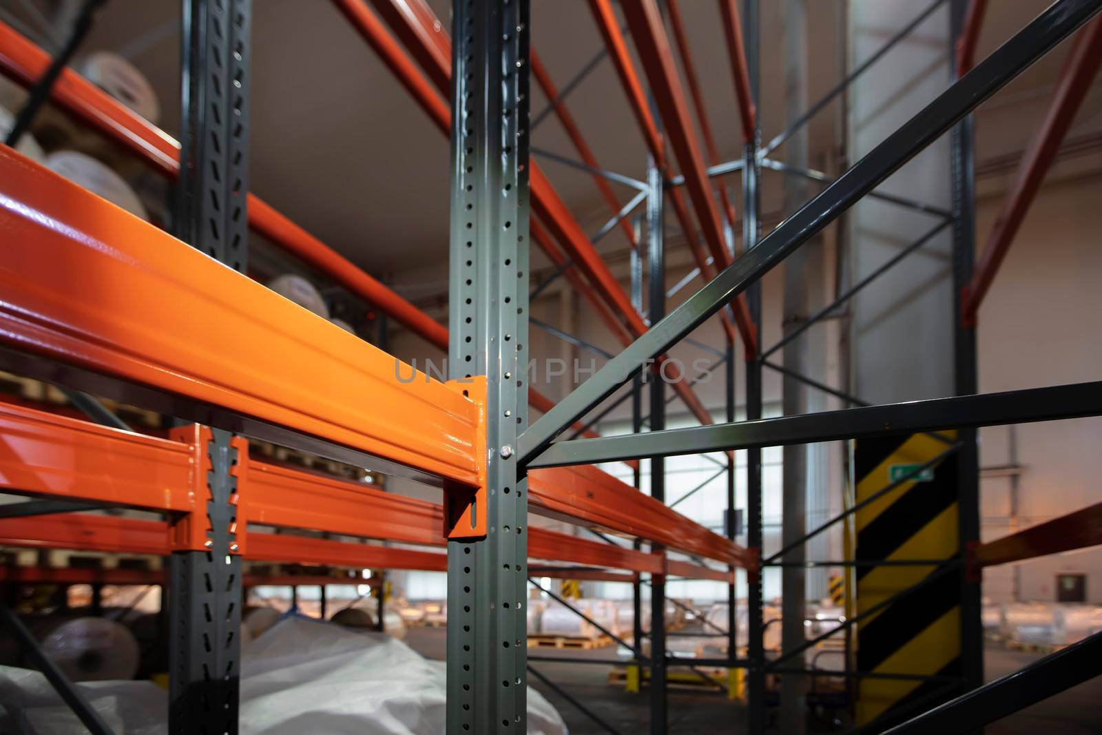 Warehouse premises of a factory or workshop with metal shelves.