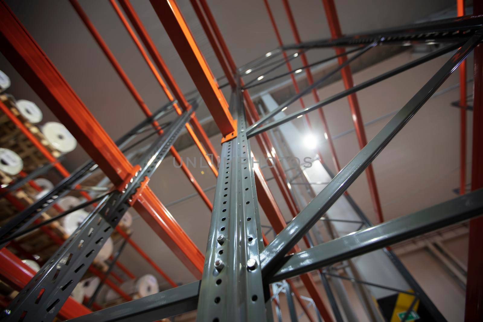 Warehouse premises of a factory or workshop with metal shelves.