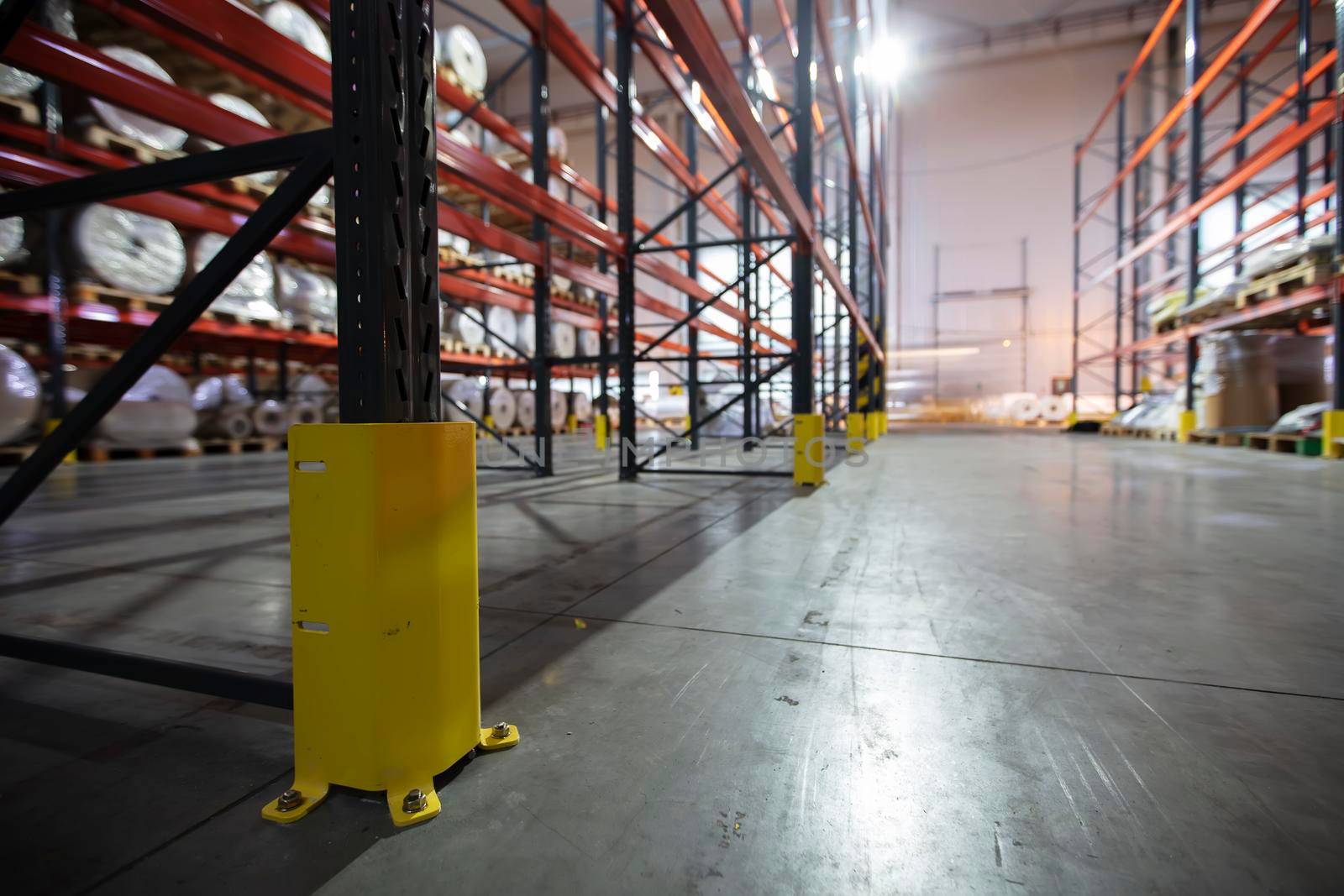 Warehouse premises of a factory or workshop with metal shelves.
