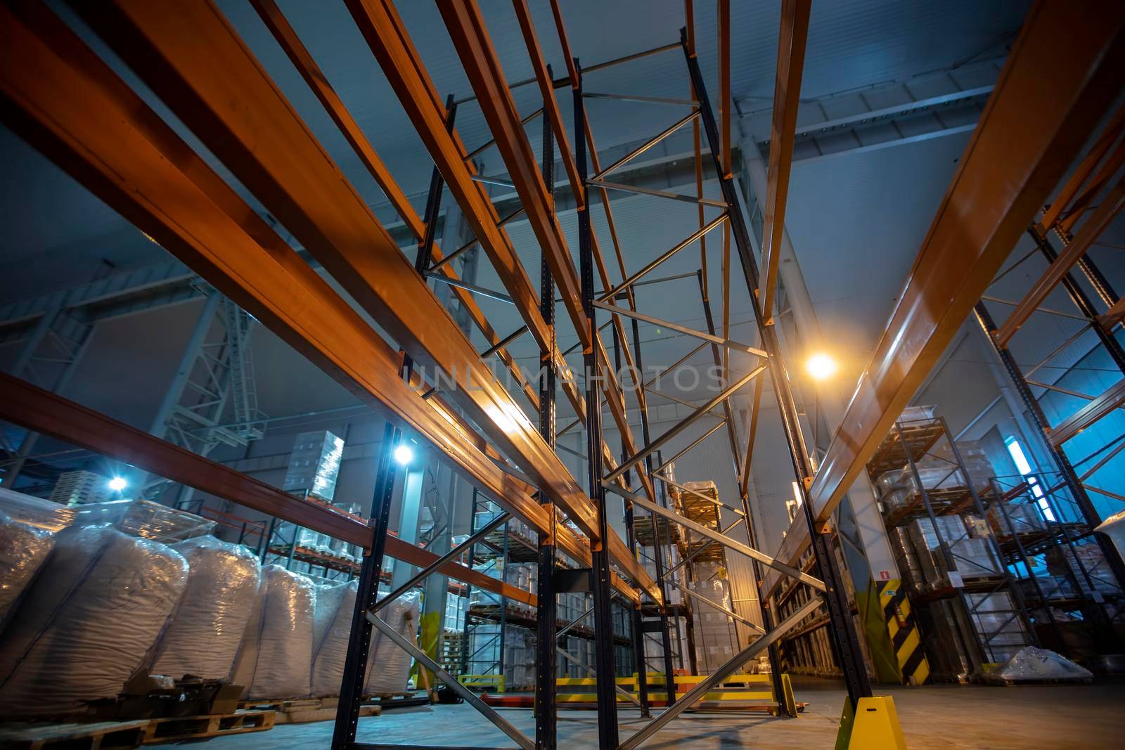 Warehouse premises of a factory or workshop with metal shelves.
