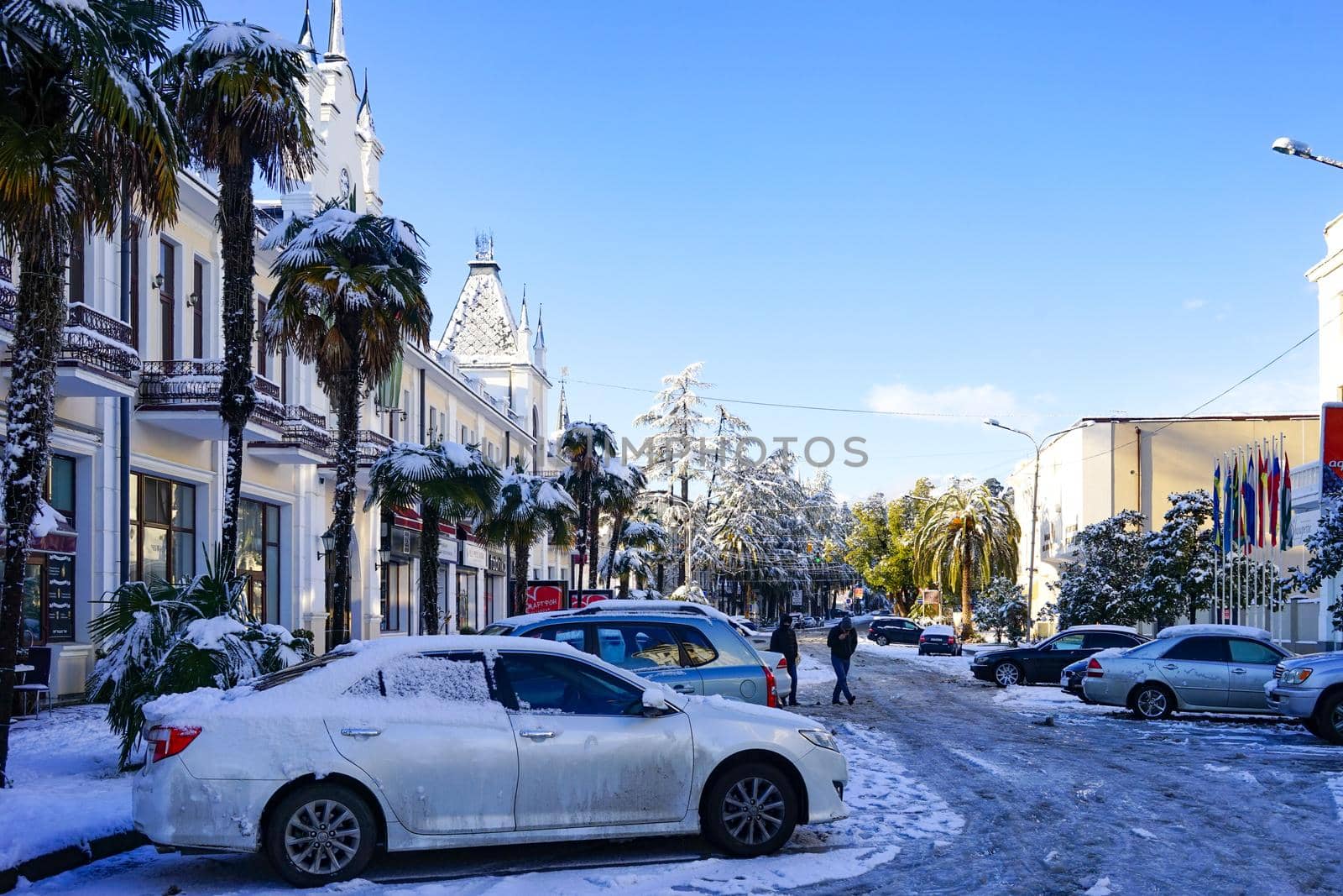 Sukhumi, Abkhazia-January 29, 2017: Urban street of the capital of Abkhazia with beautiful buildings, cars and people in a snowy winter day.