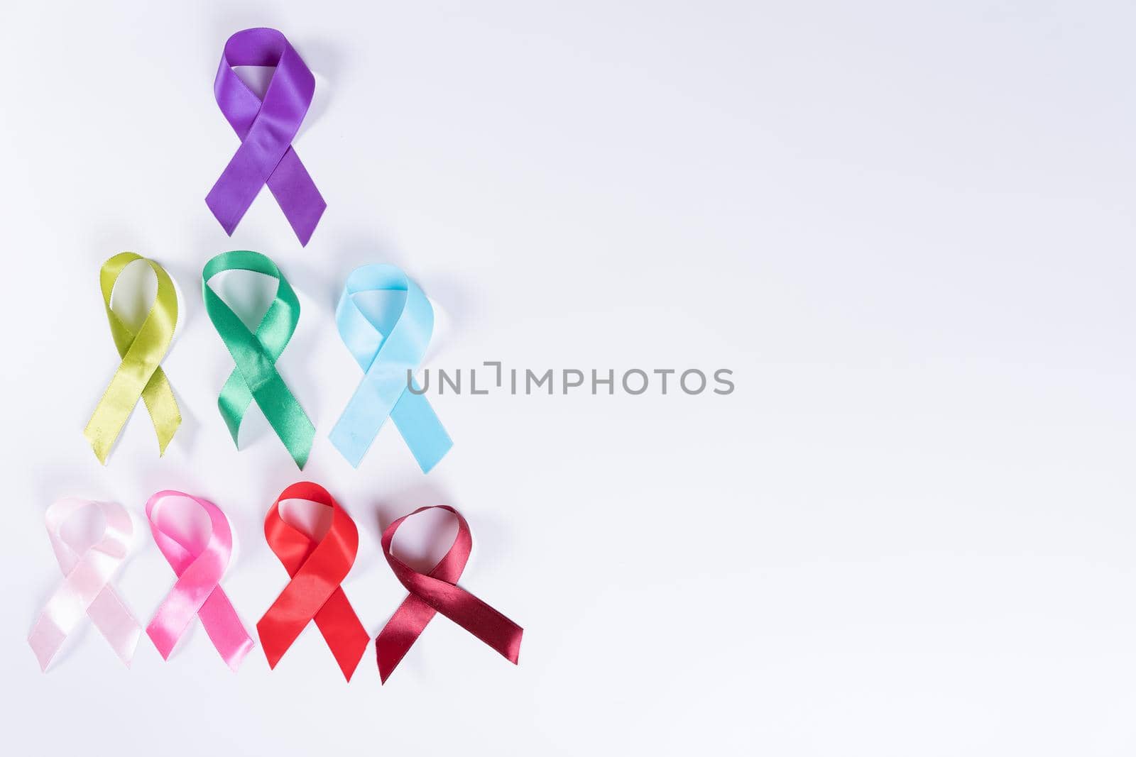 World cancer day, colorful ribbon cancer awareness on with background with copy space for text. Healthcare and medical concept.