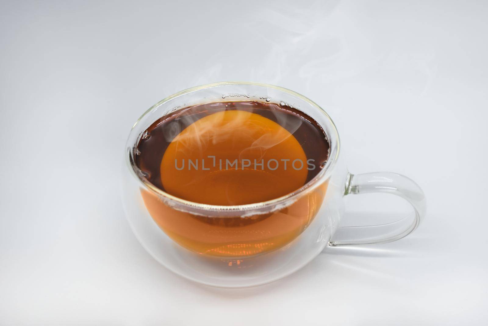 Glass cup of black tea. Isolated on white background by Nickstock