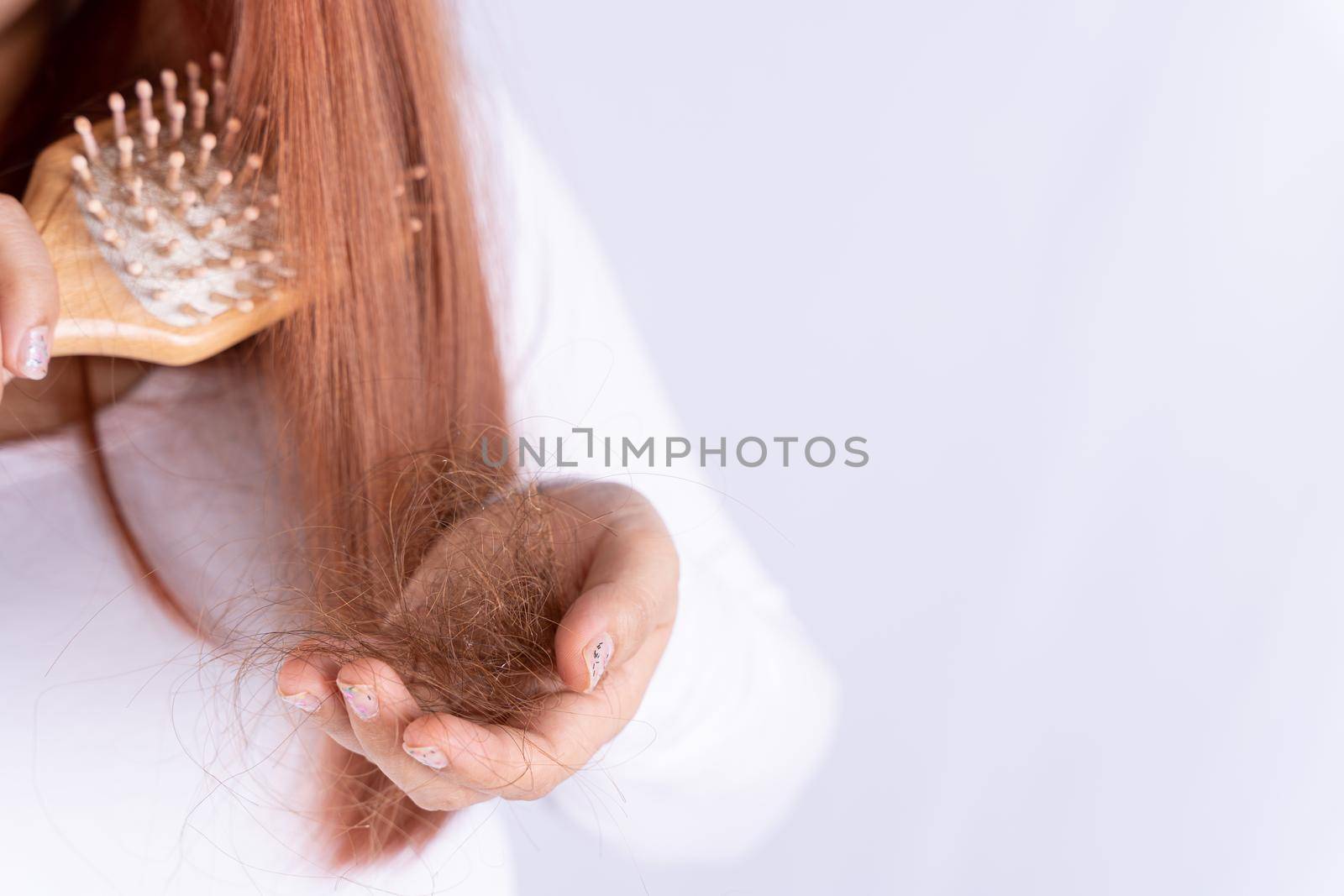 Hair fall problem, closeup hand holding comb and problem hair. Healthcare medical or daily life concept. by mikesaran