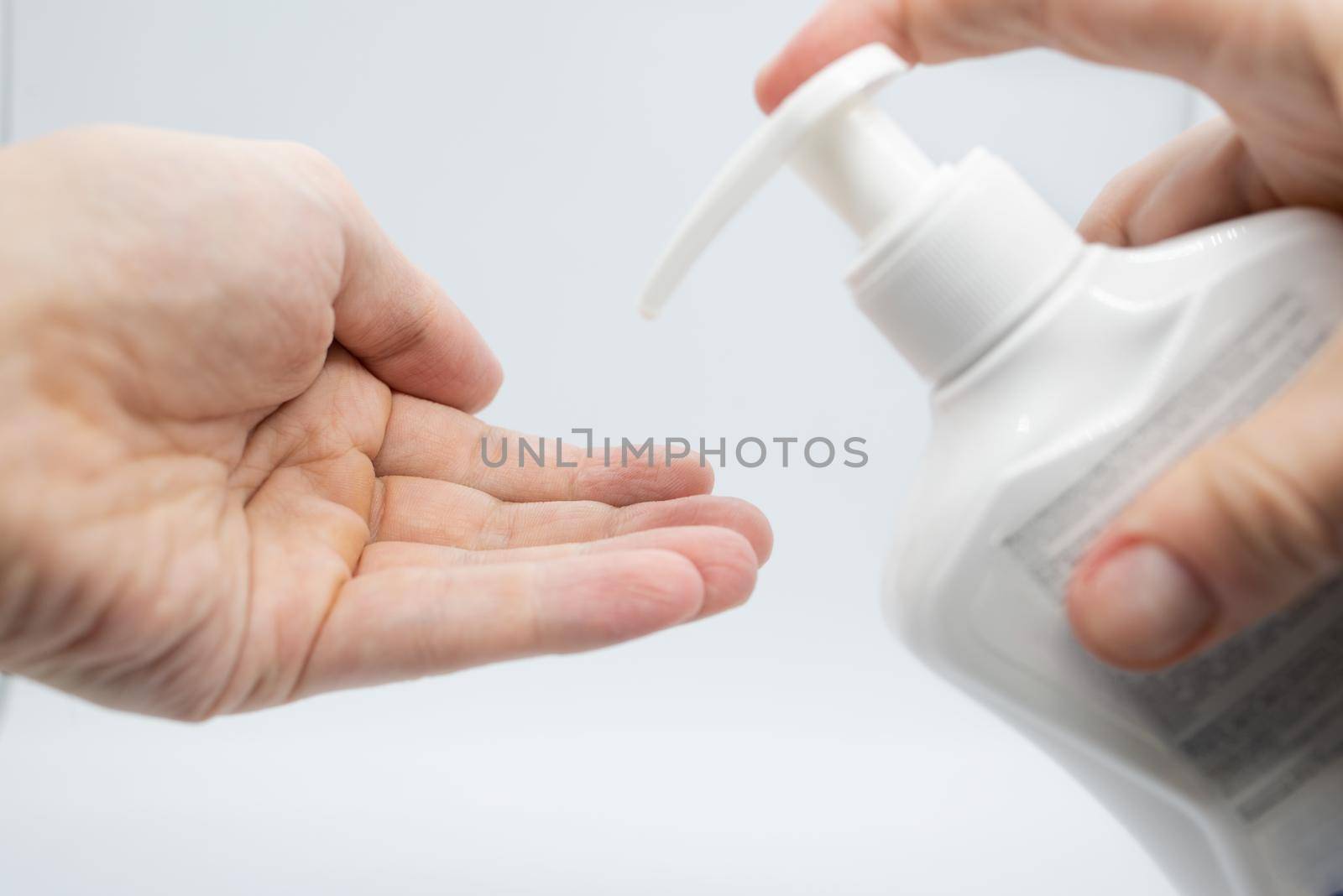 Hygiene to protect human health from viruses, hand washing with soap process. On pink background.