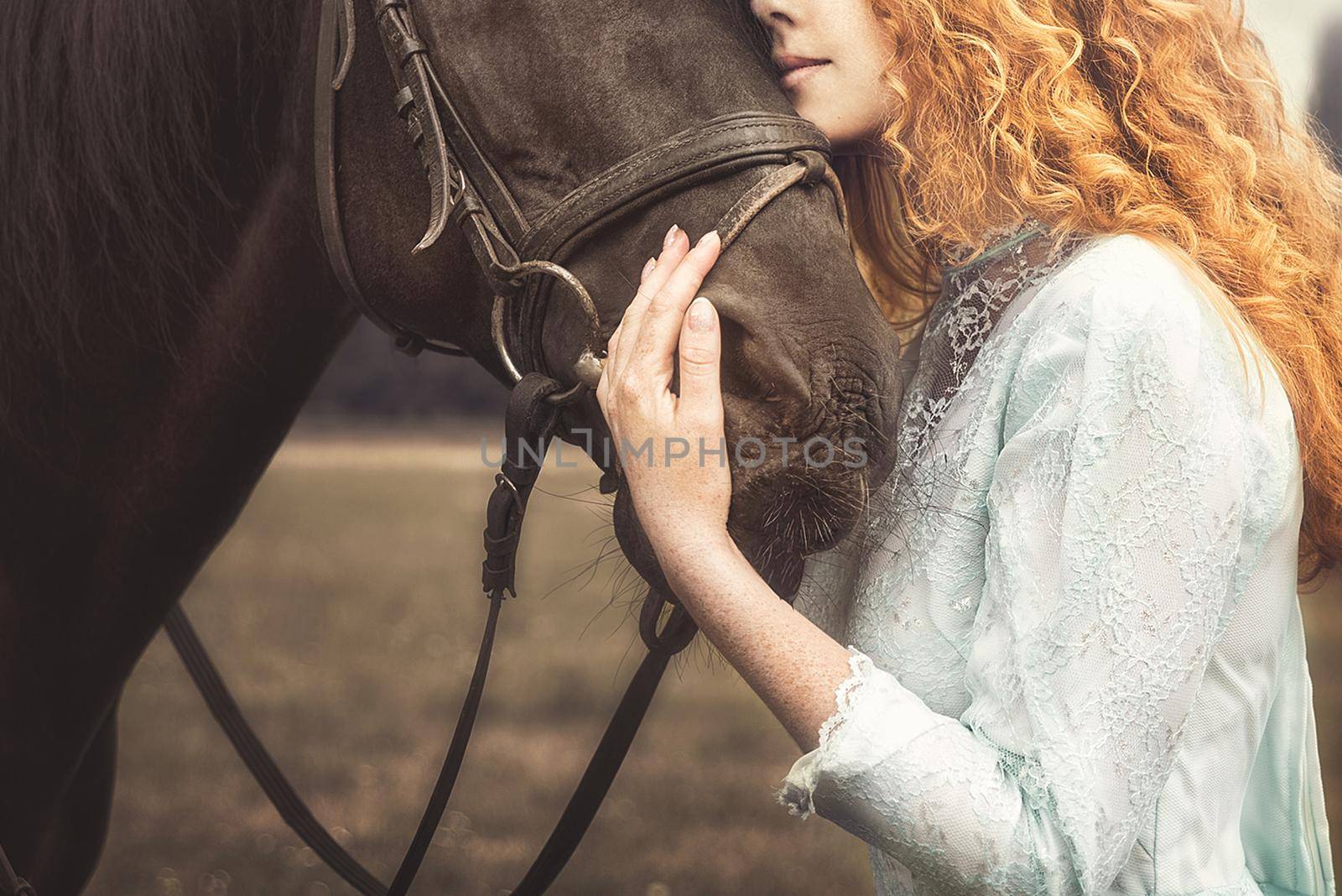 love for animals. young Woman with no face dressed in an elegant vintage dress, gently cuddling a horse, stroking his head.